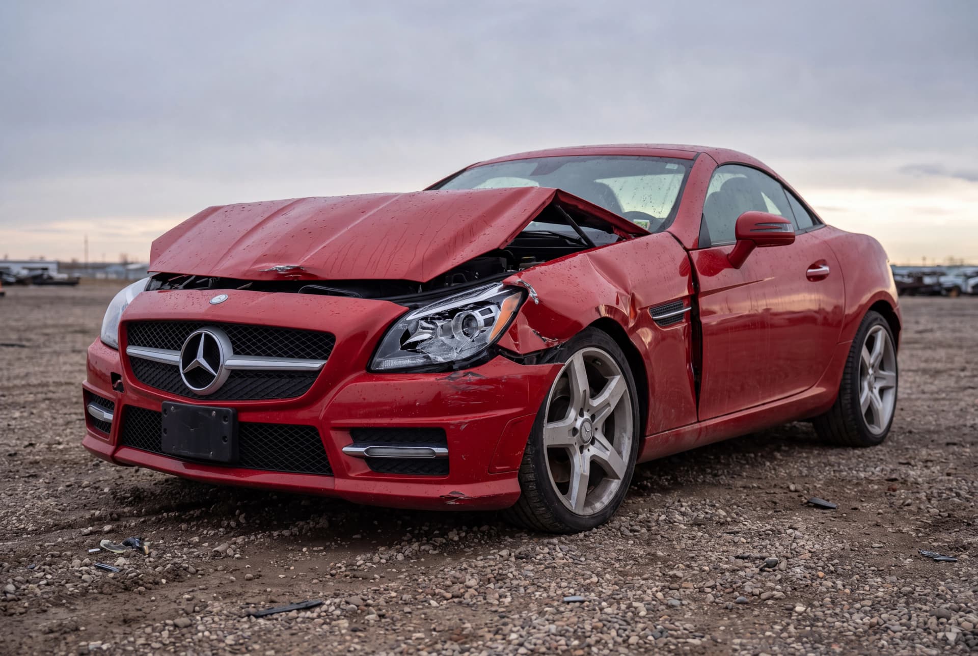 A totaled Mars Red 2014 Mercedes-Benz SLK-Class SLK250 after a front-end collision
