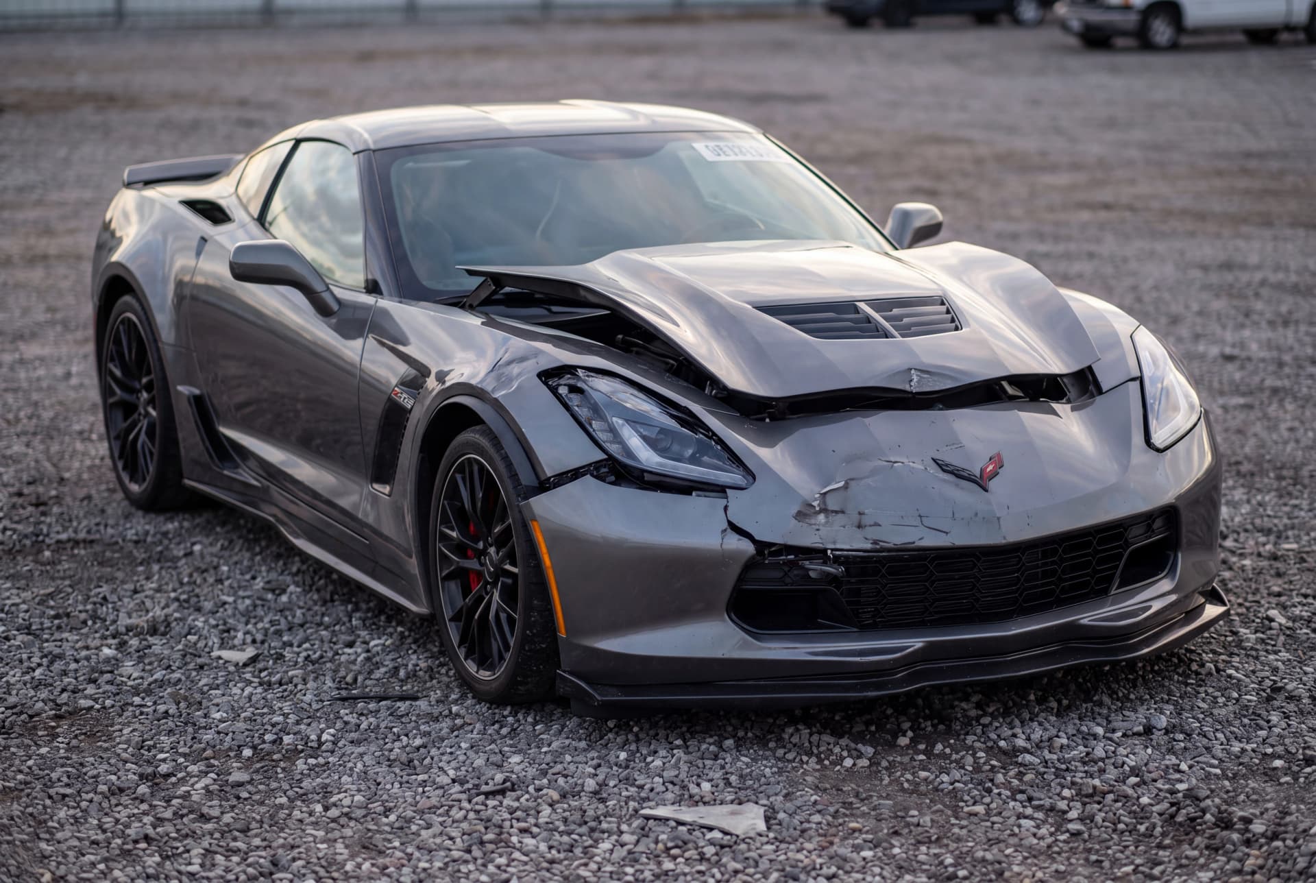 A totaled Shark Gray Metallic 2015 Chevrolet Corvette Z06 after a front-end collision
