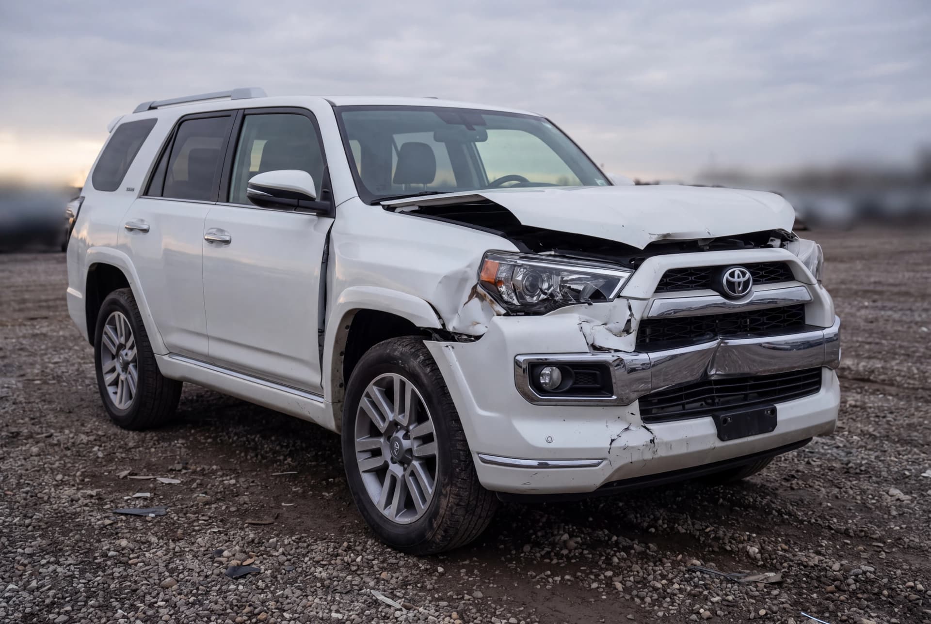 A totaled Blizzard Pearl 2016 Toyota 4Runner Limited after a front-end collision