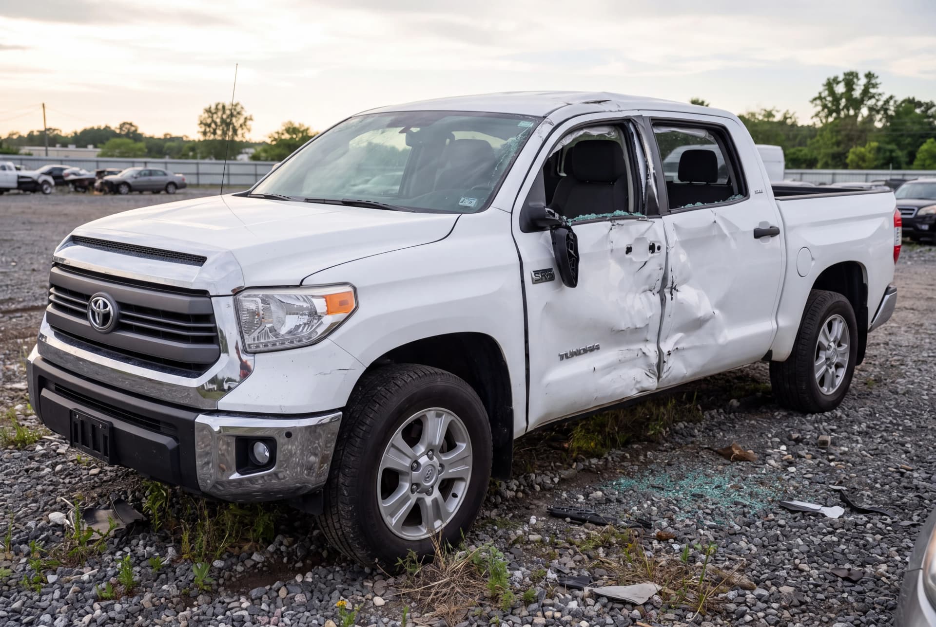 A totaled Super White 2018 Toyota Tundra SR5 after a passenger-side collision